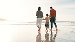 Beach, walking and kid holding hands with parents for adventure, fun or bonding together. Love, sunset and back of boy child with mom and dad by ocean on tropical vacation, holiday or weekend trip.
