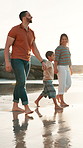 Beach, walking and family holding hands, sunshine and happiness with weekend break and travel.  Parents, mother and father with summer and seaside with vacation, boy and ocean with child and love