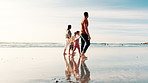 Beach, walking and family holding hands, summer and happiness with weekend break and travel. Parents, mother and father with holiday and seaside with vacation, travel and ocean with children or trip