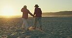 Beach, wind and holding hands with senior couple walking at sunset for love, romance or retirement. Nature, travel or relax with elderly man and woman outdoor on sand by ocean or sea for anniversary