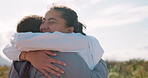 Happy, nature and girl friends hugging for good news, celebration or achievement together. Smile, high five and young women embracing with love, care and friendship in outdoor field at countryside.