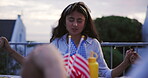 Woman, hand holding and pray for food outdoor or thanksgiving for eating, connection or American flag. Female person, group and sunset evening or religious link at table for social, event or holiday