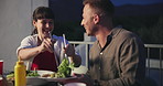 Happy people, friends and dishing salad at table for dining, eating or outdoor together at night. Young woman and man smile with healthy food or vegetables for dinner, meal or nutrition at party