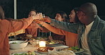 Friends, group toast and dinner on patio, night and conversation with food, new years eve and party. Women, man and outdoor at table with juice, memory or celebration with cheers, diversity or goals