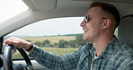 Happy man, car and driving for road trip, travel or outdoor adventure in the countryside. Young male person or driver smile in vehicle for transportation, journey or vacation on street or asphalt