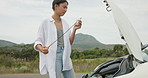 Woman, car and checking oil in nature for maintenance, trouble or problem solving for road side assistance. Female person, engineer or mechanic looking at dip stick for outdoor vehicle inspection