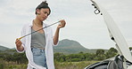 Frustrated woman, car and checking engine oil in nature for maintenance trouble, problem solving or road side assistance. Female person, engineer or mechanic looking at dip stick for outdoor vehicle