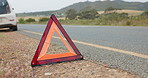 Road, triangle and car breakdown for shape, sign or vehicle assistance in the outdoor countryside. Asphalt, street or sidewalk safety symbol for warning, signal or traffic control to alert attention