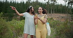 Happy woman, friends and phone in forest for social media, photography or pointing for natural outdoor scenery. Female person or people smile with mobile smartphone in nature or woods with trees