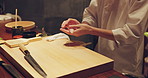 Sushi chef hands, fish and restaurant for meal prep on table at diner, cuisine and cooking in night. Person, kitchen and catering with tuna, ready and services for nutrition, diet and snack in Tokyo