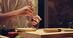 Hands, chef and brush for sushi, food or meal preparation on table for diner, cuisine or cooking in night. Person, kitchen or restaurant with soy sauce, ready and service for nutrition, diet or snack