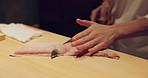 Chef hands, filet and knife for sushi, meal prep and ready in kitchen, cuisine and nutrition in restaurant. Person, cutting and fish with cooking, blade and job at diner with food, diet or catering