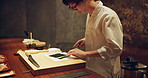 Sushi chef man, seaweed and knife for meal prep on table at diner, cuisine and cooking in night. Person, kitchen and restaurant with leaves, ready and services for nutrition, diet and snack in Tokyo