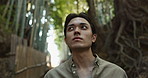 Face, thinking or Asian man in forest for journey on holiday, vacation for freedom or wellness. Hiking, travel and Japanese male person with insight for calm, peace and inspiration to relax in park