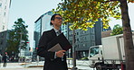 Walking, city and Asian business man with tablet, documents and file for morning commute in urban town. Professional, corporate worker and person thinking on travel for career, work and job in Japan
