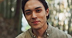 Face, portrait or happy Asian man in forest on holiday vacation for freedom or wellness in nature. Fresh air, travel or Japanese male person with smile for calm, peace or inspiration to relax in park