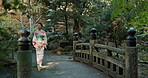 Walking, thinking or Asian woman in nature for journey on holiday vacation for freedom or wellness. Bridge, travel or Japanese person with ideas for calm, peace and inspiration to relax in forest