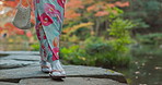 Walking, lake or legs of woman in nature for journey on holiday vacation for freedom or wellness. Park, travel or feet of Japanese person on rocks for health, peace and inspiration to relax in forest