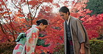 Japanese people in park, bow and traditional clothes with hello, nature and sunshine with respect and culture. Couple outdoor together in garden, greeting with modesty and tradition, polite and kind