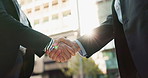 Business people, handshake and city for partnership, agreement or greeting in outdoor deal or meeting. Closeup of employees shaking hands outside for b2b, teamwork or hiring in an urban town together