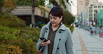 Phone, walking and business woman in the city networking on social media, mobile app or internet. Technology, street and professional Asian female person with cellphone commuting in street in town.