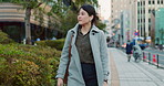 Woman, Asian and walk on sidewalk, travel or commute to work with professional in city with earphones. Listening to music on journey, podcast and commuter on urban street in Tokyo with playlist