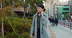 Woman, Asian and walking, travel or commute to work with professional in city with earphones. Listening to music on journey, podcast and commuter on urban street or sidewalk in Tokyo with playlist