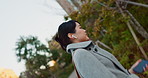 Woman, Asian and earphones, travel in city and commute to work with radio or podcast outdoor. Technology, spin and listening to music on journey, urban street and professional walking outdoor
