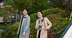 Walking, conversation and business women in the city talking for communication or bonding. Smile, discussion and professional Asian female people speaking and laughing together commuting in town.