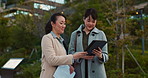 Tablet, conversation and business women in the city talking for communication or bonding. Smile, discussion and professional Asian female people speaking with digital technology together in town.