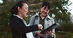 Asian woman, tablet and team in city of Japan for communication, research or social media together. Business people smile on technology for online search, chat or networking on sidewalk in urban town