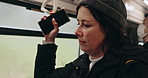 Train, subway and woman in city for travel, commute and journey on metro transportation in town. Passenger, railway station and person standing with smartphone on underground trip in public transport