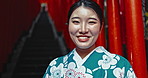 Face, happy woman and Japanese culture at temple for religion, worship or smile with kimono in Tokyo. Portrait, lady or traditional clothes at spiritual shinto building for fashion, faith or heritage