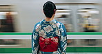 Japanese woman, back and train station for travel with fast vehicle, motion blur and traditional clothes. Person, indigenous fashion and style for culture in city for metro transport with locomotive