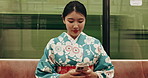 Train, travel and Japanese woman with phone in traditional clothes, culture and indigenous style in subway. Fashion, social media and person in fast vehicle, metro transport and trip in urban town