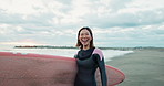 Asian woman, surfboard and happy by ocean, smile and ready for workout, training or wellness in morning. Person, surfer and excited at beach, waves and nature for health, exercise and walk in Japan