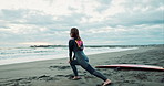 Surfer woman, stretching legs and beach with back, ready and workout for training, wellness and morning. Person, athlete and lunges by sea, waves and nature for health, muscle or performance in Japan