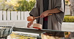 Shinto temple, person and wash hands at fountain, container or cleaning for worship with faith. Religion, mindfulness and purification ritual to stop evil, bacteria or splash ladle at shrine in Tokyo