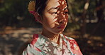 Face, thinking or Asian woman in nature for journey on holiday, vacation for freedom or wellness. Girl, travel or Japanese female person with ideas for calm, peace or inspiration to relax in park