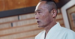 Master, karate or Asian man in dojo for martial arts for fitness, discipline or self defense for honor. Training, workout or senior kung fu professional talking for fighting, teaching or sports class