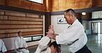 Students, karate class or Asian man teaching martial arts in dojo for fitness, discipline or self defense for combat. Demonstration, workout or kung fu master training a person for fighting education