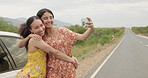 Women, friends and selfie by car on road trip with memory, profile picture and happy with kiss in countryside. Girl, photography and together with hug, bonding and care for post on social network