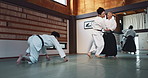 Martial arts, sensei and Japanese students with training, fitness and action in class for defence or technique. Aikido, people or fighting with discipline, uniform or confidence for culture and skill