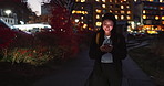 Happy asian woman, phone or walking at night in networking, outdoor communication or social media in city. Person relax on mobile smartphone in late evening for online chatting in urban town of Japan