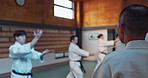 Japanese men, aikido class and instructor for fighting, modern martial arts and learning self defence. Teacher, students or exercise in life energy, training or strong in active combat for discipline