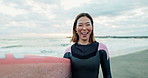 Surfer woman, face and board at beach, smile or ready for workout, training or wellness in morning. Person, happy and ocean with surfboard by sea, waves or ocean in portrait with water sport in Japan