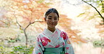 Japanese fashion, kimono and face of girl outdoor in garden or forest with a smile. Traditional, style and happy portrait of woman in culture dress robe and relax in nature, woods or park with pride