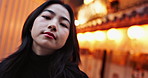 Japanese woman, outdoor and night in city with light, bokeh and face on walk, tourism or adventure in street. Person, portrait and adventure to explore town, holiday or vacation on sidewalk in Tokyo