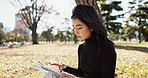 Outdoor, park and Japanese woman with tablet, thinking and internet with social media, typing and mobile user. Person, outside or girl with technology, digital app and email notification with contact