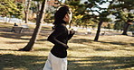 Freedom, park running and Japanese woman in nature with jog, travel and outdoor in fall. Happy, fitness and garden with a female person from Japan on vacation and holiday with smile and confidence